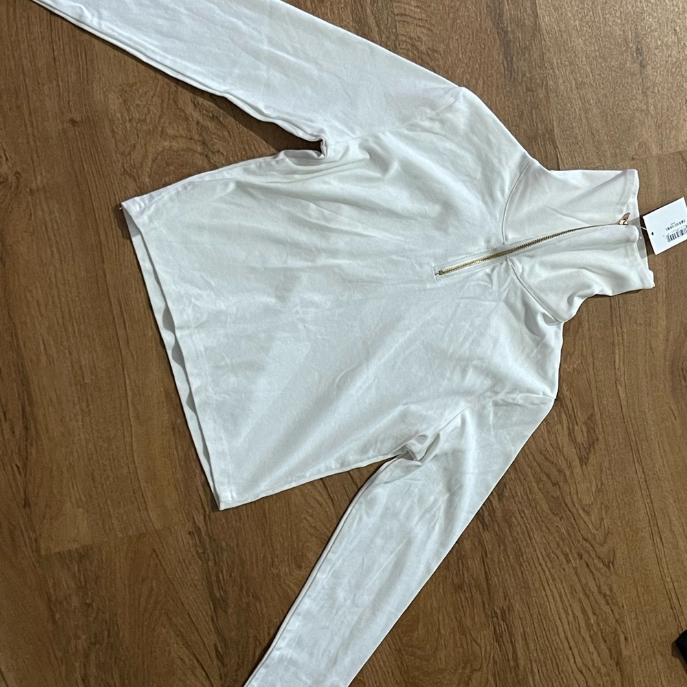 Long sleeve crop top. Can be worn with zipper down.